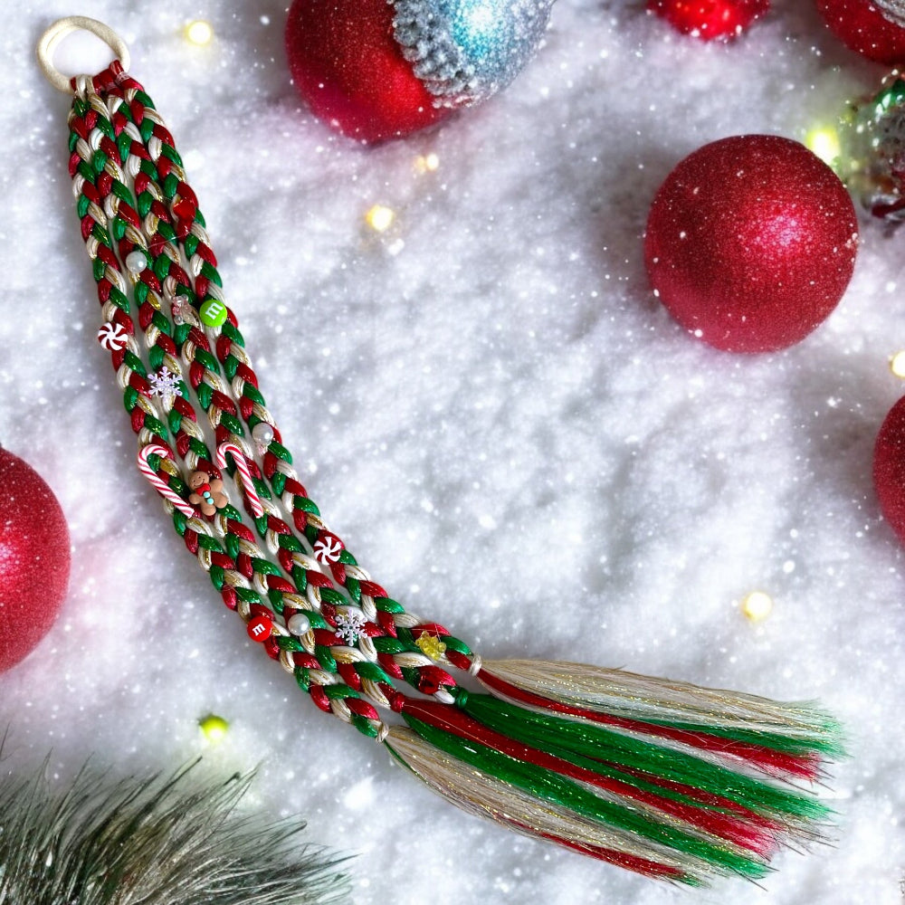 Braided Christmas decoration with tassels on a snowy background