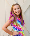 Girl models purple and hot pink clip-in hair extensions for kids