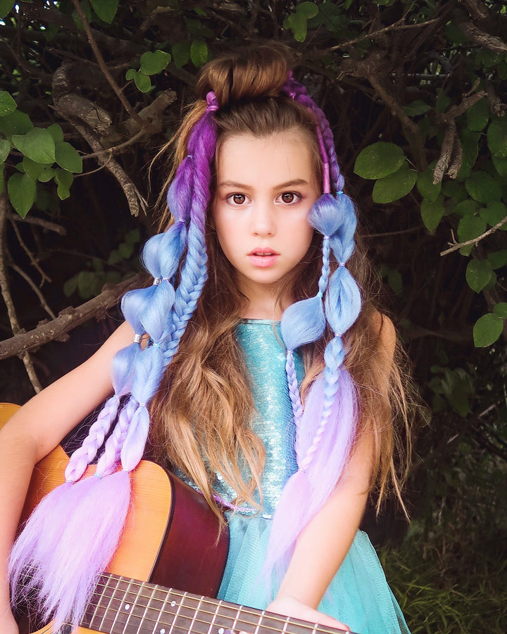 Model wearing a set of purple and aqua braids that clip-in for festival hairstyles
