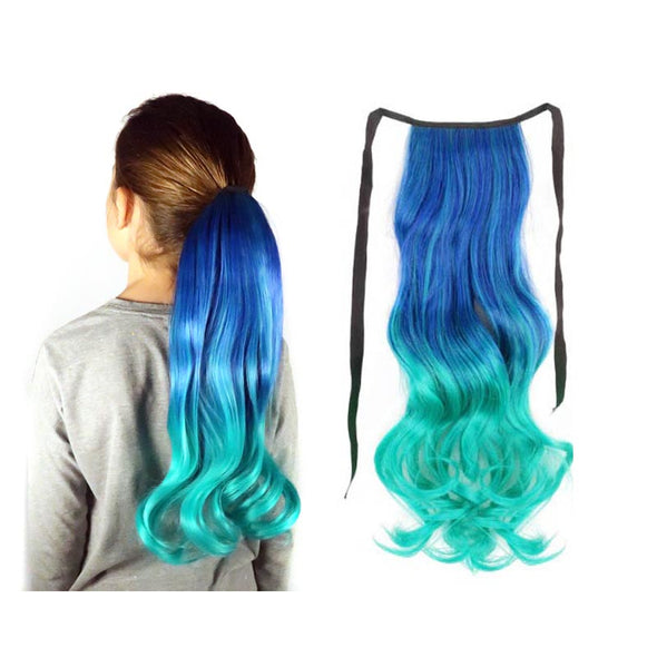 A young model wears a teal blue, green and aqua ombre hair extension ponytail