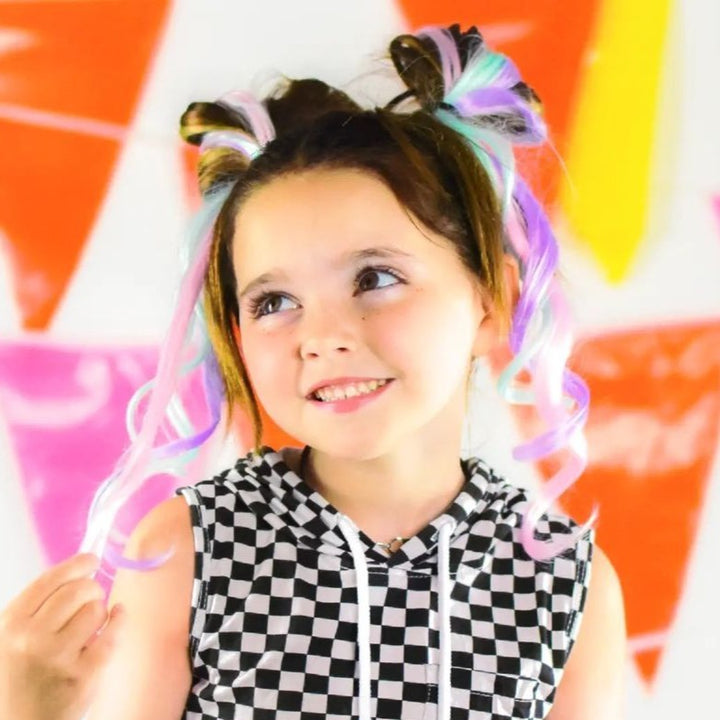 Young girl models pastel colored clip in hair extensions in pink mint and lavender