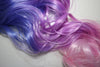 Detail of pastel synthetic hair extension in blues, lilac lavender purple, pinks