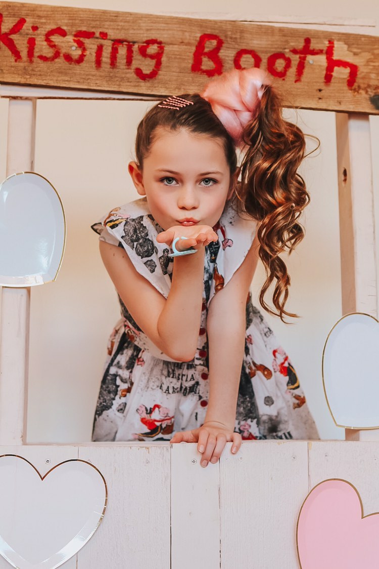 Young kid models pink hair extensions